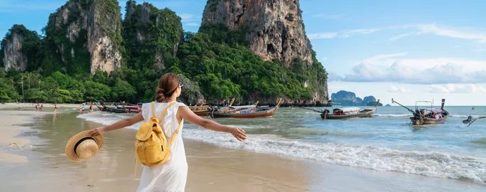 Young female traveler enjoying a summer vacation o