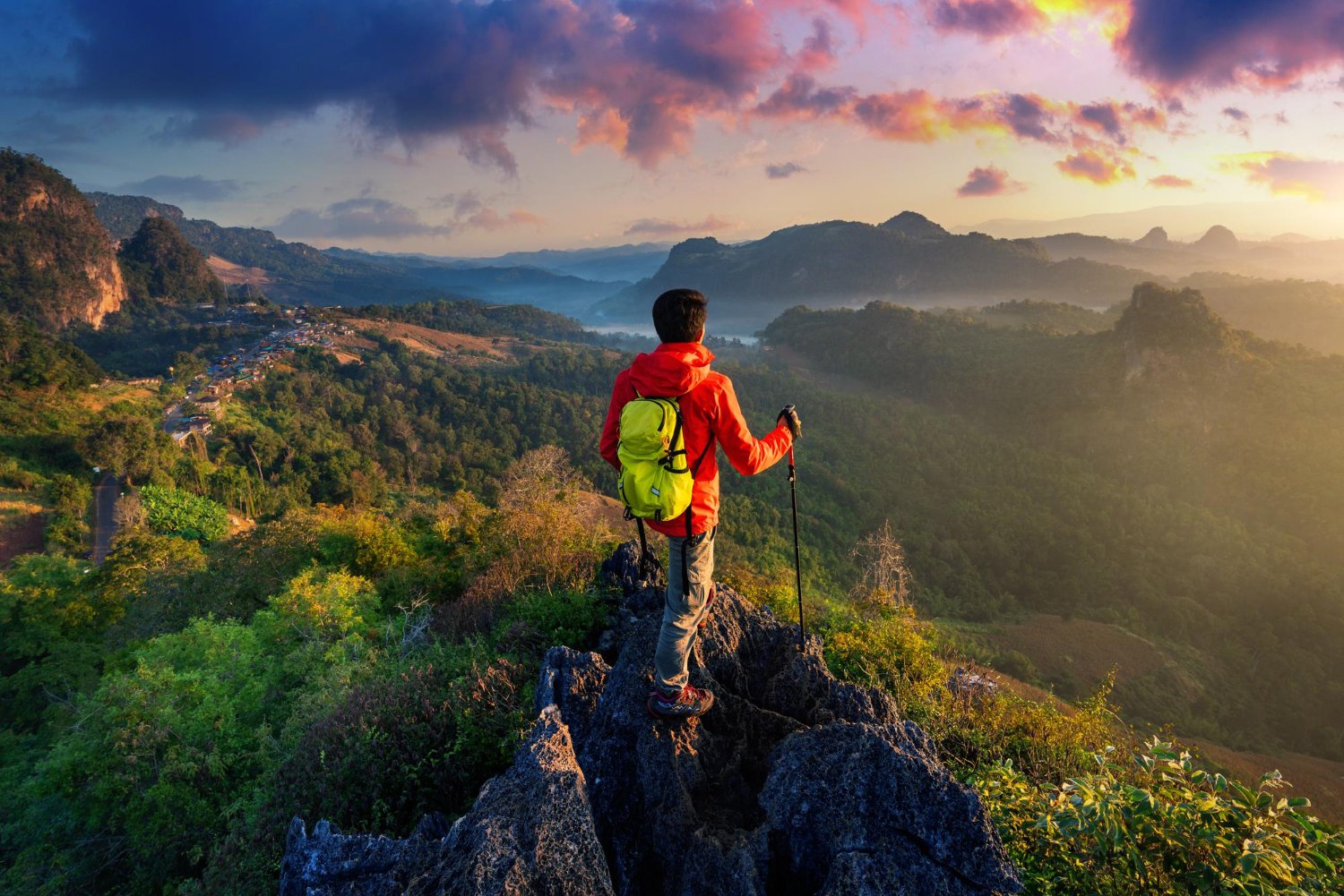 Solo traveler hiking above a mountain valley