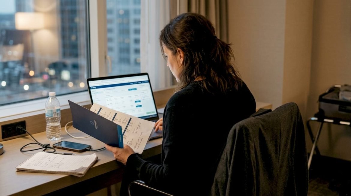 Business traveler checking travel prices in hotel