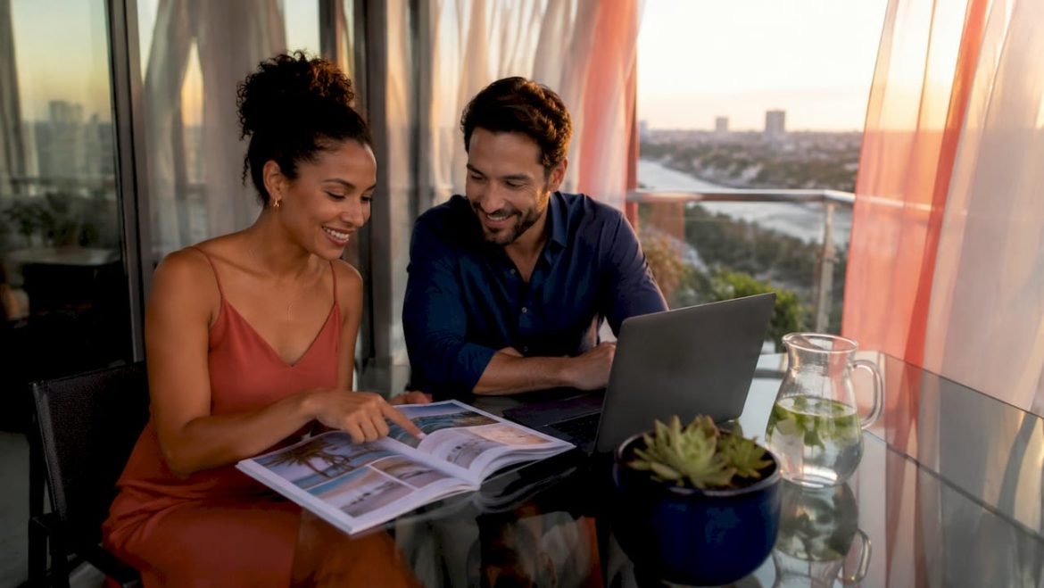 Couple planning honeymoon destinations at home