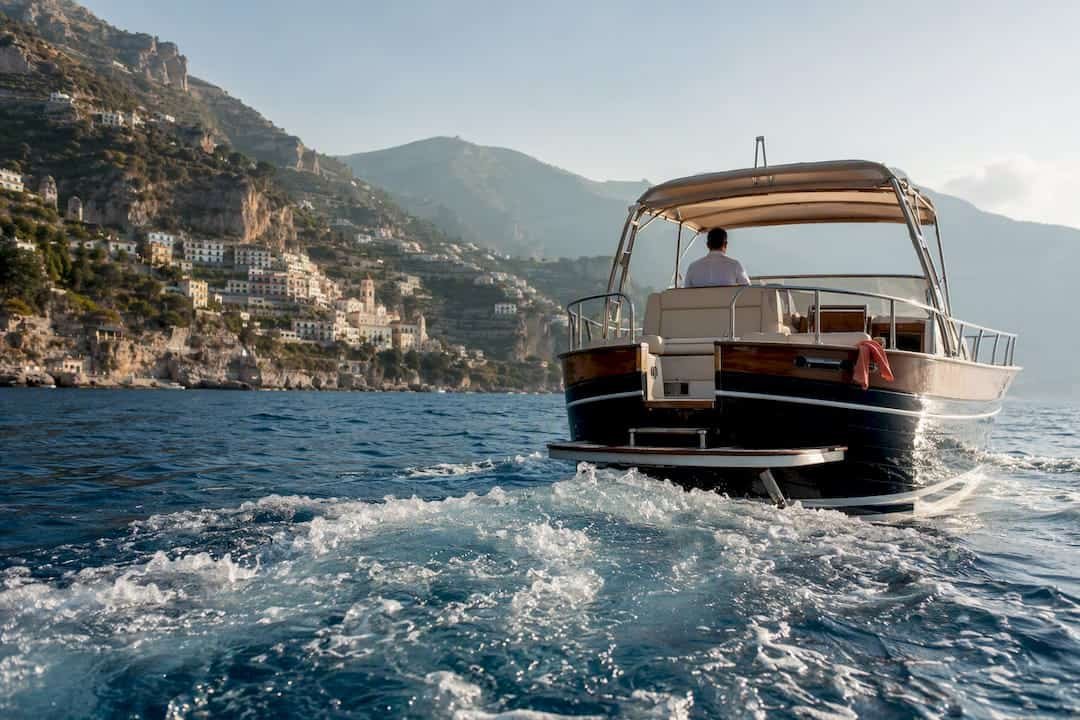 Private boat passing Amalfi Coast cliffs