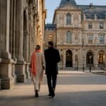 Couple walking through Paris museum courtyard